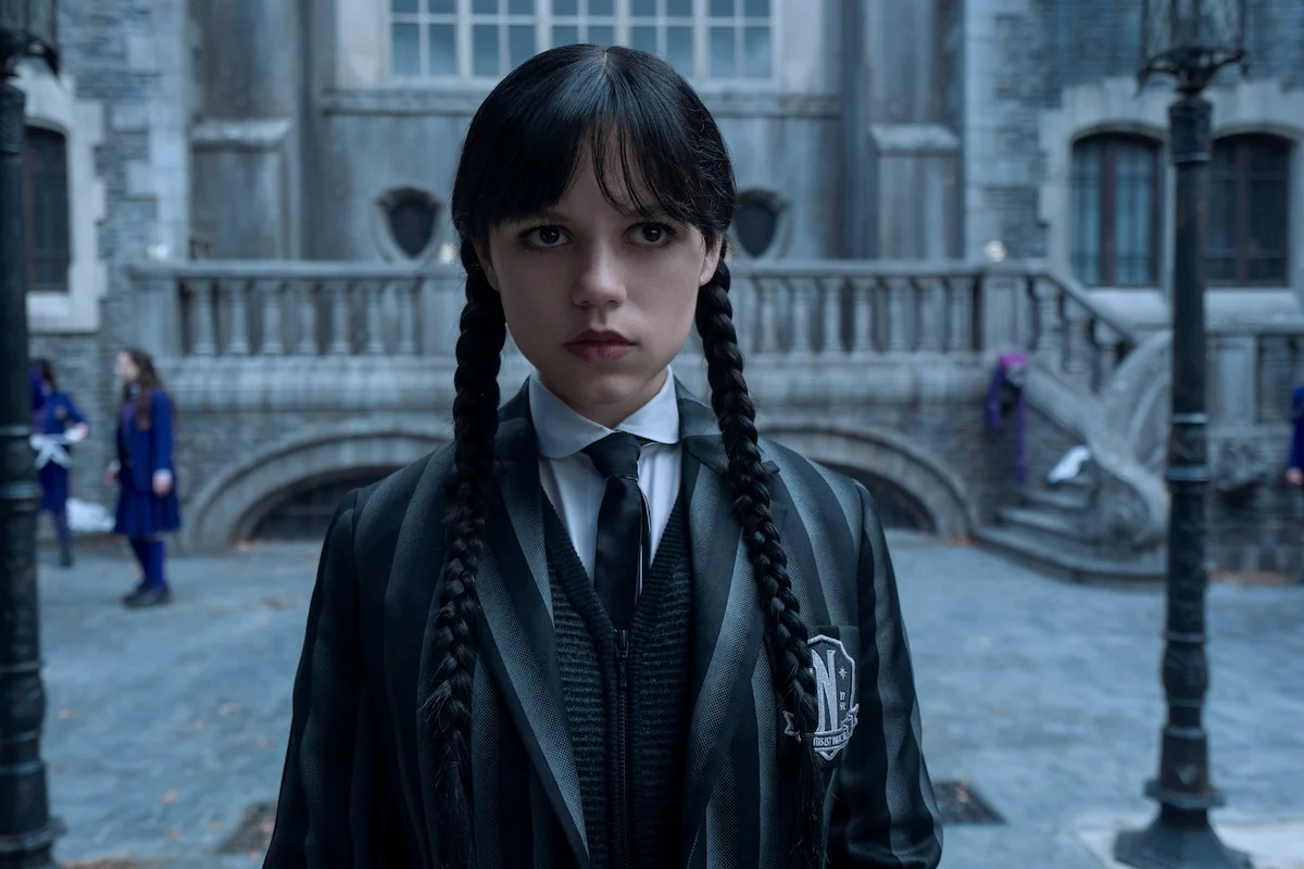Jenna Ortega as Wednesday Addams stands in the courtyard at Nevermore Academy in Wednesday Season 2