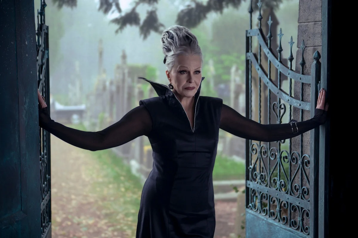 Joanna Lumley as Grandmama at an iron gateway in a Wednesday Season 2 still on Netflix